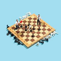 Image showing Business decision making concept. Miniature people : small businessman figure standing and walking on chessboard with chess pieces