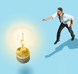 Image showing Concept of a new idea. A man going with a lamp