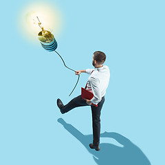 Image showing Concept of a new idea. A man going with a lamp