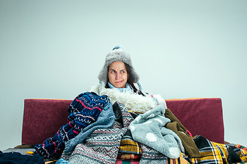 Image showing The young woman with Flue Sitting on Sofa at Home. Healthcare Concepts.