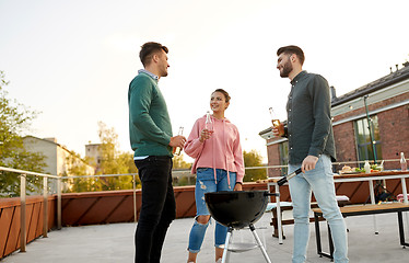 Image showing happy friends having bbq party on rooftop