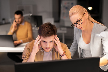 Image showing business team with computer working late at office