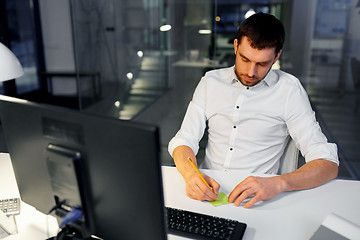 Image showing businessman with computer working at night office