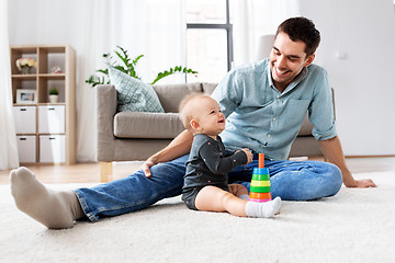 Image showing father playing with little baby daughter at home