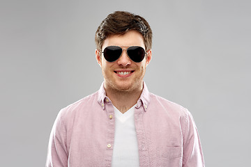 Image showing smiling young man in shirt and aviator sunglasses