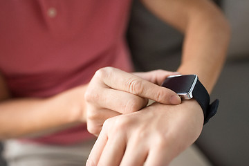 Image showing close up of male hands with smart watch