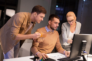 Image showing business team with computer working late at office