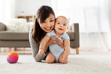 Image showing happy young mother with little baby at home