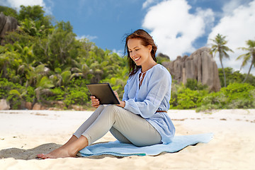 Image showing happy smiling woman with tablet pc on summer beach