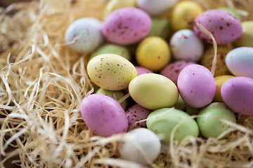 Image showing close up of easter egg candies in straw nest