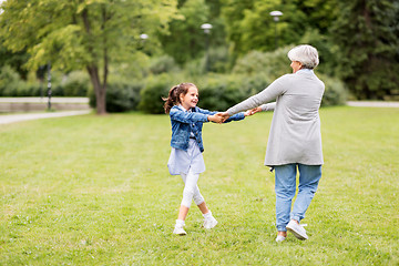 Image showing grandmother and granddaughter playing at park