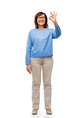 Image showing happy senior woman in glasses showing ok hand sign