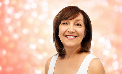 Image showing portrait of smiling senior woman over white