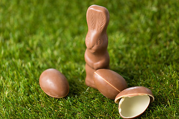Image showing chocolate bunny and easter eggs on grass