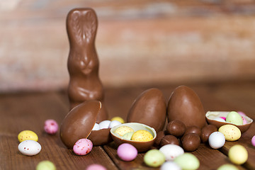 Image showing chocolate eggs, easter bunny and candies on wood