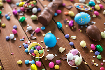 Image showing chocolate eggs, easter bunny and candies on wood