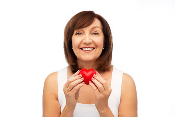 Image showing portrait of smiling senior woman holding red heart