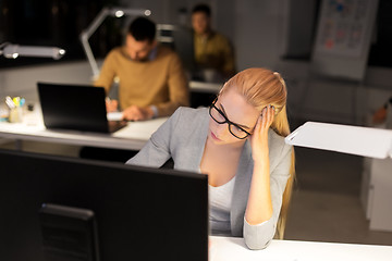 Image showing tired businesswoman working at night office