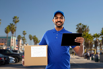 Image showing indian delivery man with tablet pc and parcel box