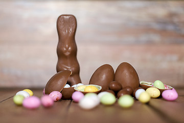 Image showing chocolate eggs, easter bunny and candies on wood