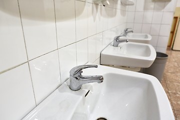 Image showing Taps an basins in a row