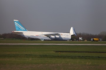 Image showing BUDAPEST, HUNGARY - APRIL 16: Antonov An-124 cargo plane at Budapest Airport on April 16, 2013. The aircraft is being loaded by an oversize truck with 100 tons of cargo.