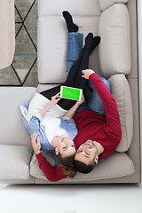 Image showing couple relaxing at  home with tablet computers