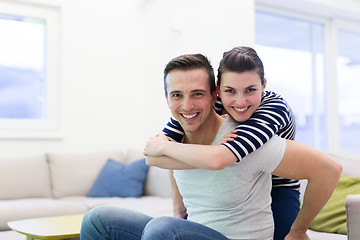 Image showing handsome man piggybacking his girlfriend