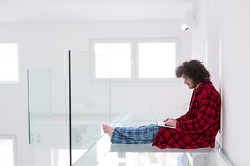 Image showing young freelancer in bathrobe working from home