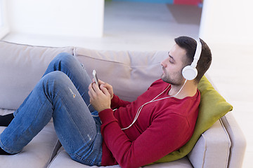 Image showing man enjoying music through headphones