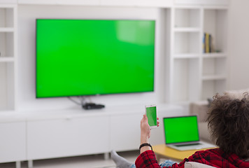 Image showing young man in bathrobe enjoying free time