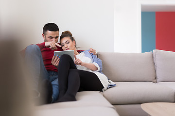 Image showing couple relaxing at  home with tablet computers