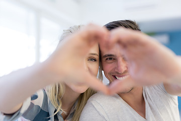 Image showing couple making heart with hands