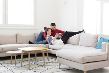 Image showing couple relaxing at  home with tablet computers