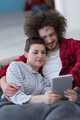 Image showing couple relaxing at  home with tablet computers