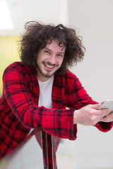 Image showing young freelancer using tablet computer