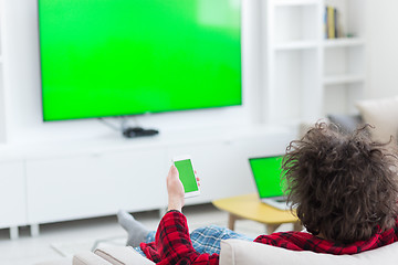 Image showing young man in bathrobe enjoying free time