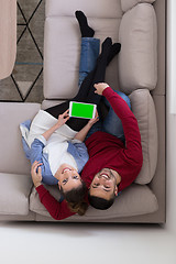 Image showing couple relaxing at  home with tablet computers