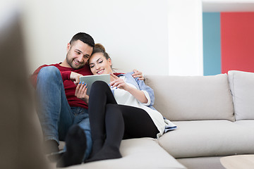 Image showing couple relaxing at  home with tablet computers