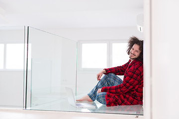 Image showing young freelancer in bathrobe working from home