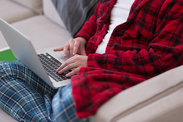 Image showing man freelancer in bathrobe working from home