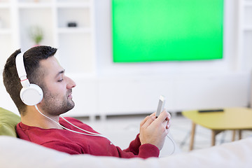 Image showing man enjoying music through headphones