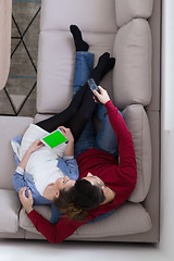 Image showing Young couple on the sofa watching television top view