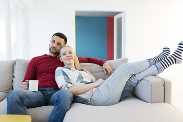 Image showing couple hugging and relaxing on sofa