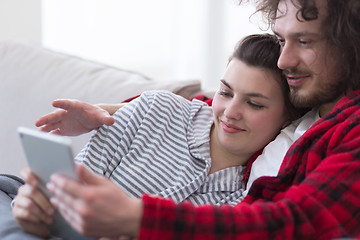 Image showing couple relaxing at  home with tablet computers