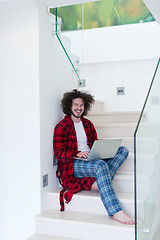 Image showing freelancer in bathrobe working from home