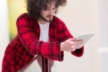 Image showing young freelancer using tablet computer