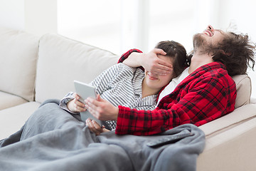 Image showing couple relaxing at  home with tablet computers