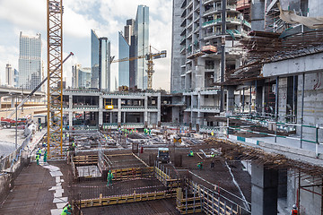 Image showing Laborers working on modern constraction site works in Dubai. Fast urban development consept