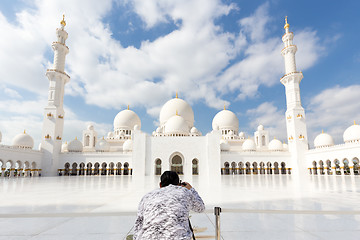 Image showing Male tourist taking photo Sheikh Zayed Grand Mosque in Abu Dhabi, the capital city of United Arab Emirates